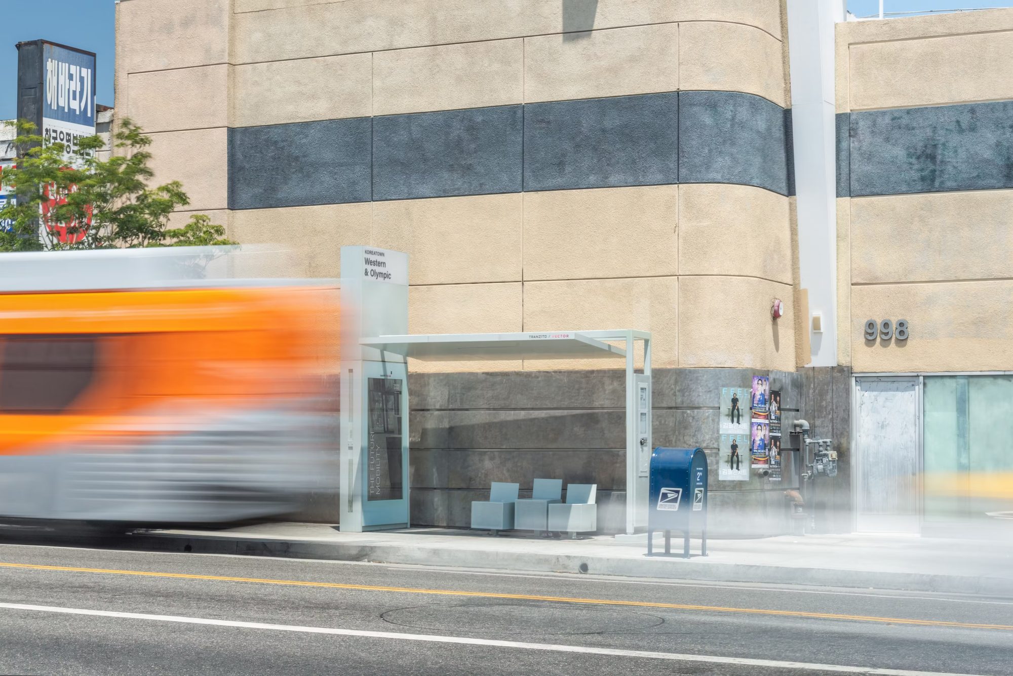 A bus speeds past a new STAP shelter on a Los Angeles street